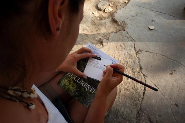 Researcher Roxana Nicoară filling in a field note, as contribution to the speculative research enabled by Sabina Suru's work. Photo credit: Alexandra Costea
