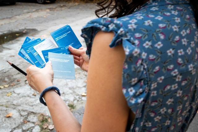 Contributor Adelina Scorobete browsing through the speculative research toolkit Concrete & Canopy, part of Sabina Suru's work. Photo credit: Alexandra Costea