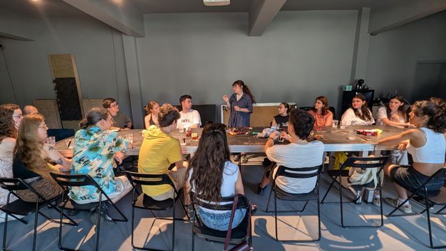 Participants gather around the workbench for an introductory session on energy harvesting principles
